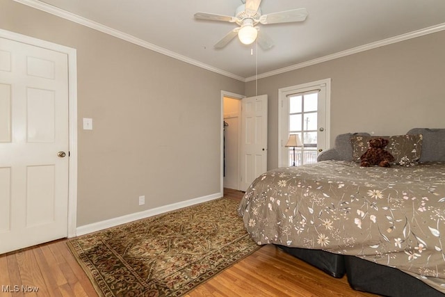 bedroom with hardwood / wood-style flooring, ceiling fan, and crown molding