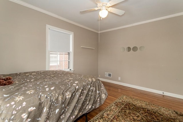 bedroom featuring crown molding, ceiling fan, and hardwood / wood-style flooring