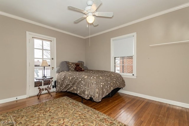 bedroom featuring hardwood / wood-style flooring, ornamental molding, and ceiling fan