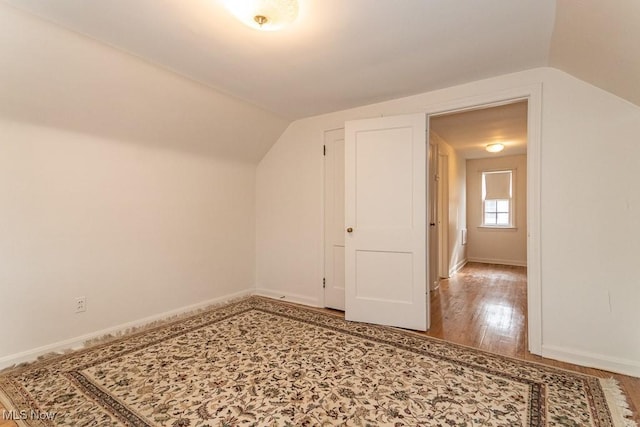 bonus room featuring lofted ceiling and hardwood / wood-style floors