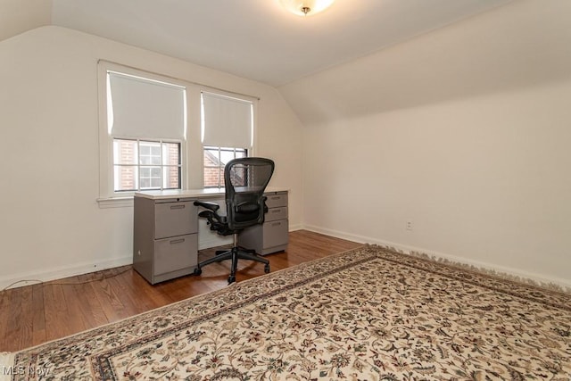 office space featuring vaulted ceiling and wood-type flooring