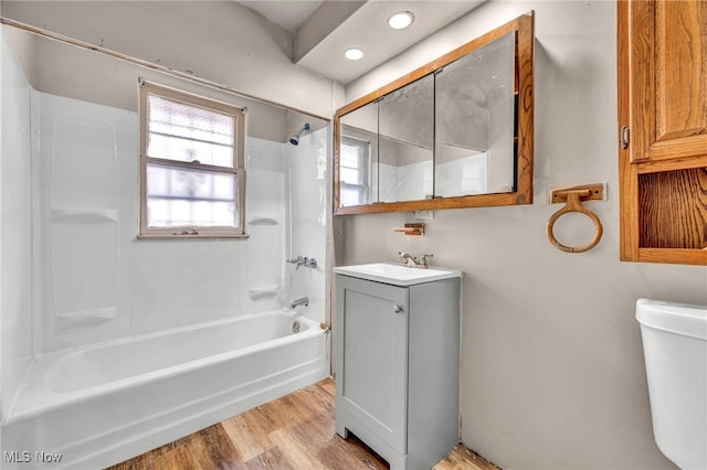 full bathroom with wood-type flooring, toilet, shower / bathing tub combination, and vanity