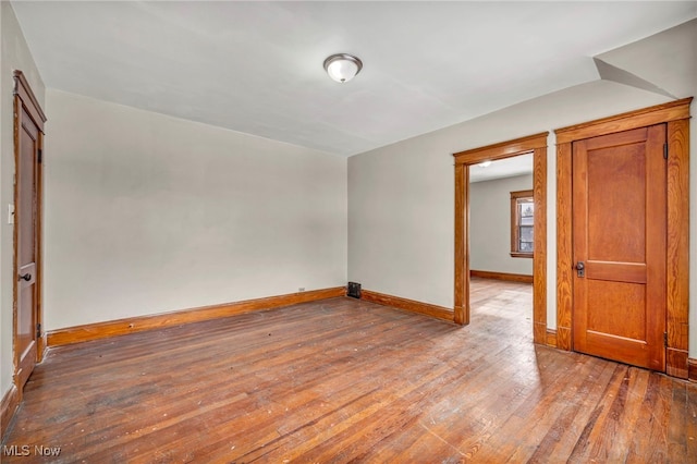 empty room with hardwood / wood-style floors