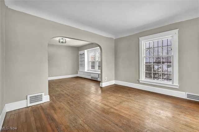 unfurnished room with dark hardwood / wood-style floors