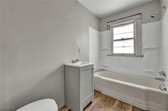 full bathroom with vanity, shower / bathing tub combination, toilet, and hardwood / wood-style flooring