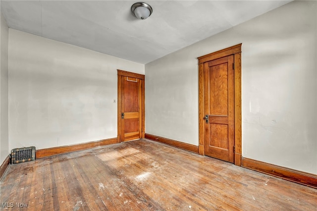 unfurnished room with light wood-type flooring