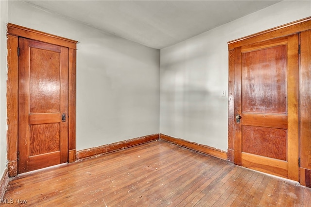 spare room with hardwood / wood-style floors