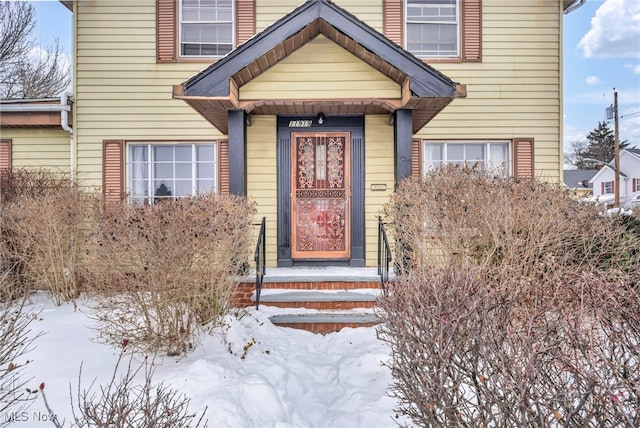 view of snow covered property entrance