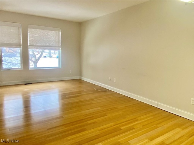 spare room featuring light hardwood / wood-style flooring