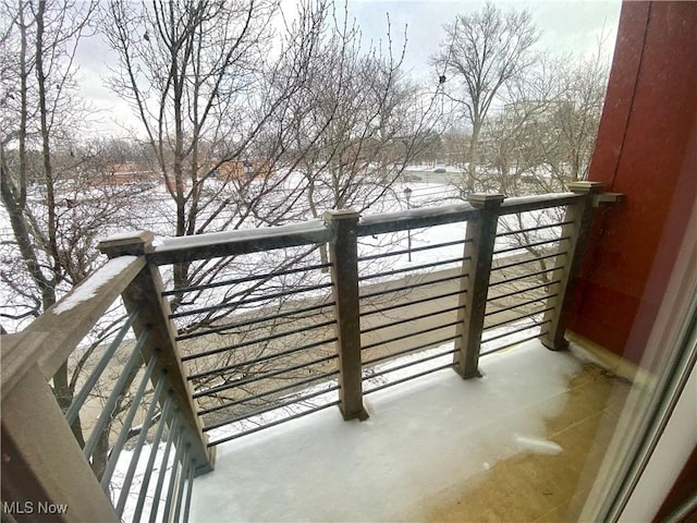 view of snow covered back of property