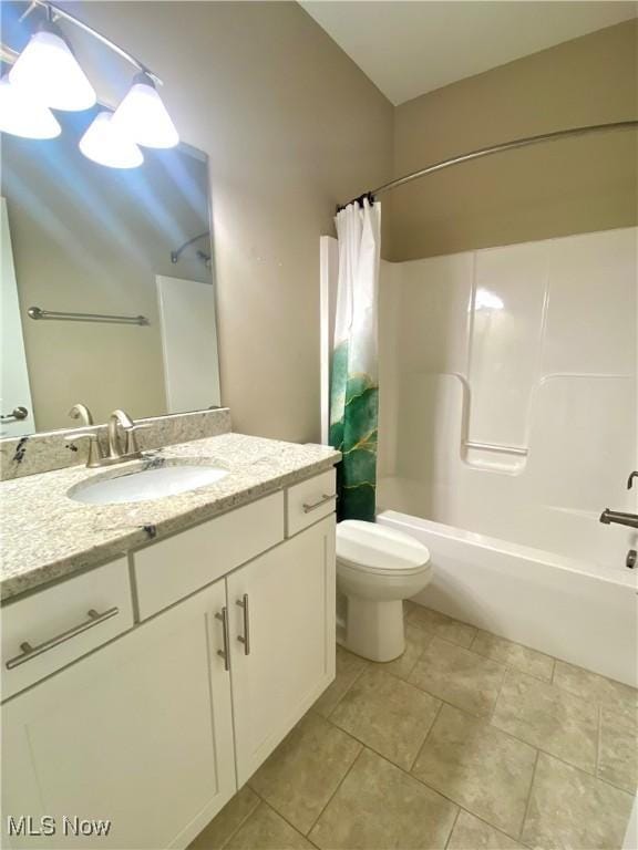 full bathroom with vanity, tile patterned floors, toilet, and shower / tub combo with curtain