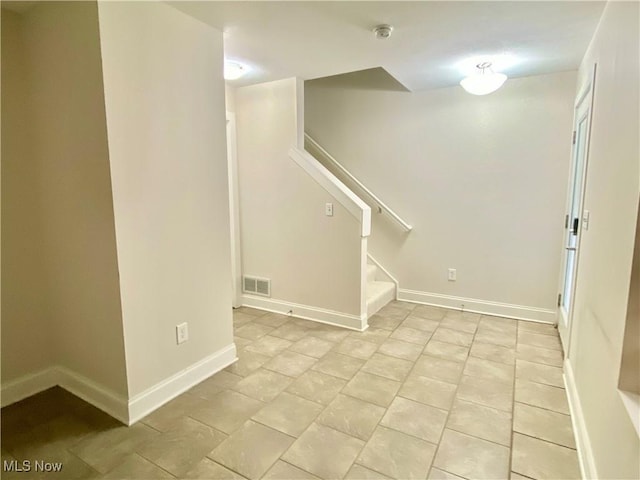 basement featuring light tile patterned flooring