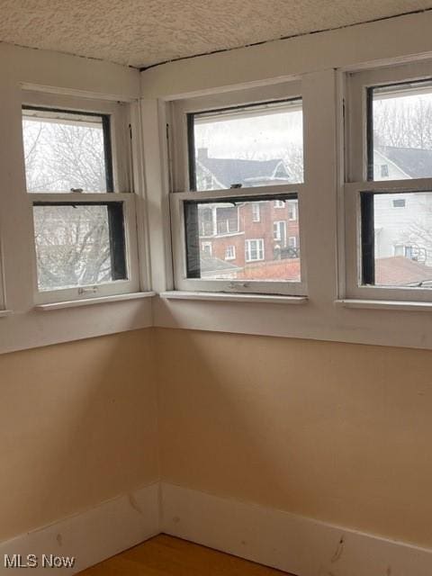 spare room featuring a healthy amount of sunlight and a textured ceiling