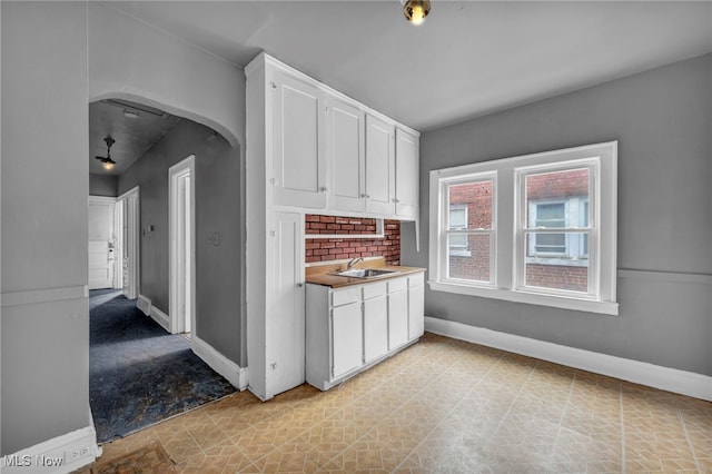 kitchen with white cabinetry and sink