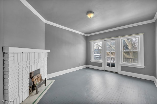 unfurnished living room featuring hardwood / wood-style flooring, crown molding, and a brick fireplace