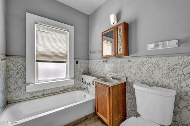 bathroom featuring vanity, a tub, tile walls, and toilet