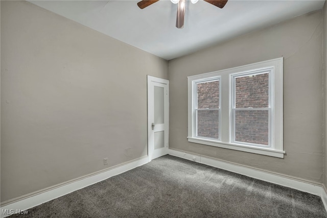 carpeted spare room featuring ceiling fan