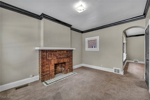 unfurnished living room featuring ornamental molding, carpet flooring, and a brick fireplace