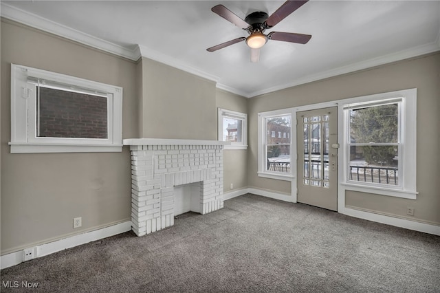 unfurnished living room featuring ceiling fan, ornamental molding, carpet floors, and a brick fireplace