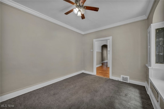 unfurnished room with ceiling fan, ornamental molding, and carpet