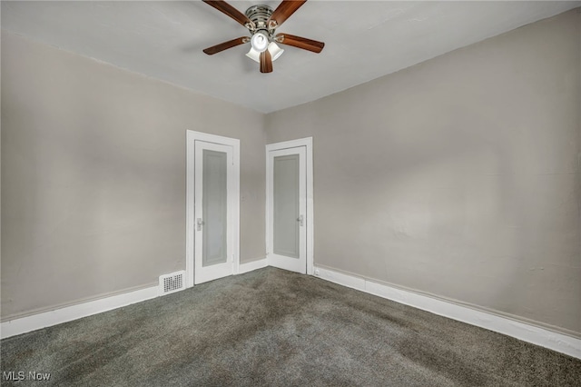 empty room featuring ceiling fan and carpet