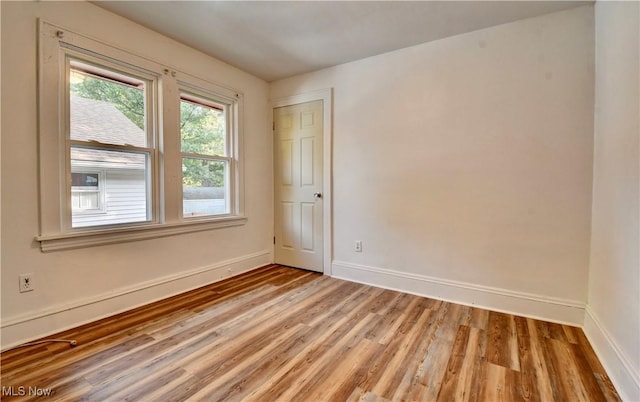 unfurnished room with light hardwood / wood-style floors