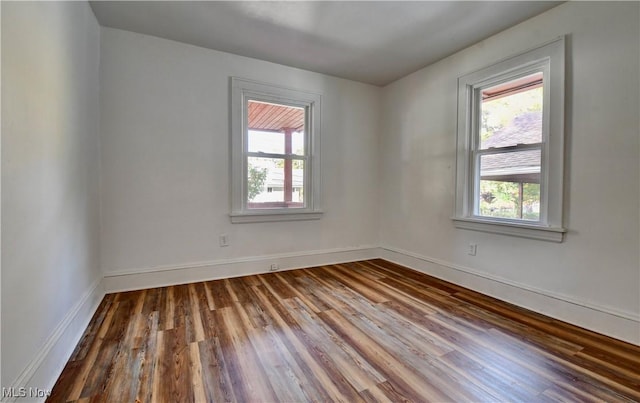 empty room featuring hardwood / wood-style flooring and a healthy amount of sunlight