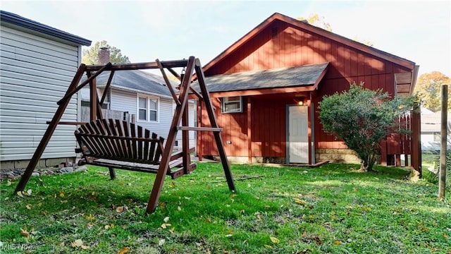 back of house featuring a shed and a yard