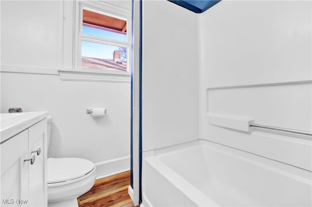 full bathroom featuring washtub / shower combination, vanity, toilet, and hardwood / wood-style floors