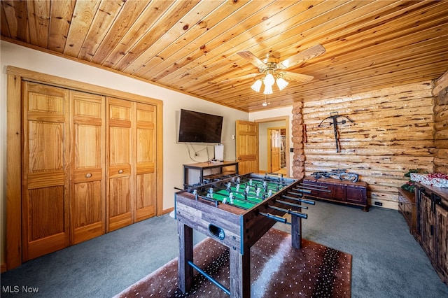 rec room with wood ceiling, log walls, ceiling fan, and dark colored carpet