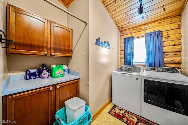 laundry room with light tile patterned flooring, washer and dryer, rustic walls, cabinets, and wooden ceiling