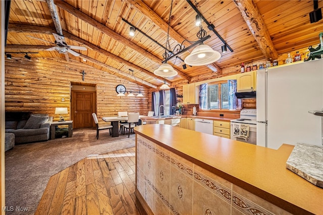 kitchen with hanging light fixtures, wooden ceiling, white appliances, and beam ceiling