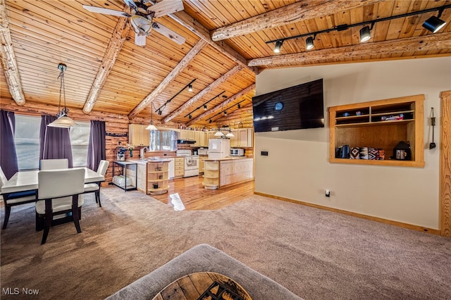 living room featuring lofted ceiling with beams, rail lighting, rustic walls, light colored carpet, and wooden ceiling