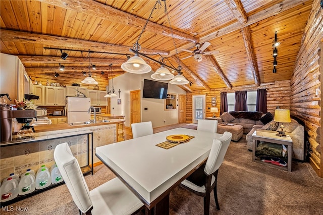 carpeted dining area featuring wood ceiling, rail lighting, rustic walls, and beam ceiling