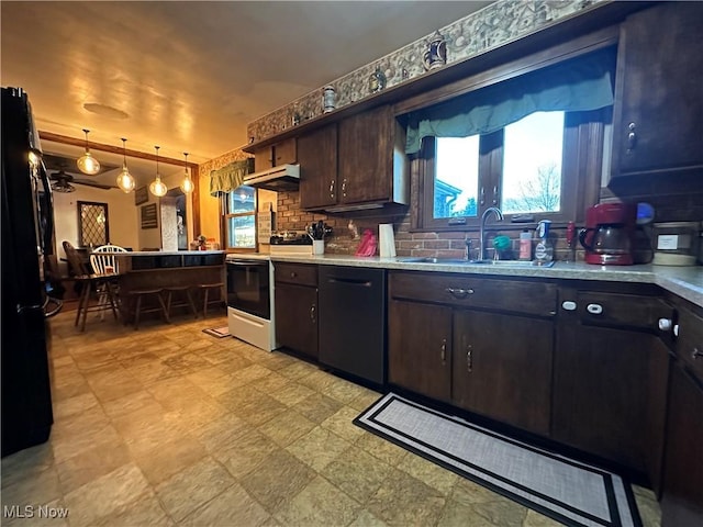 kitchen featuring sink, hanging light fixtures, dark brown cabinets, black refrigerator, and electric range oven