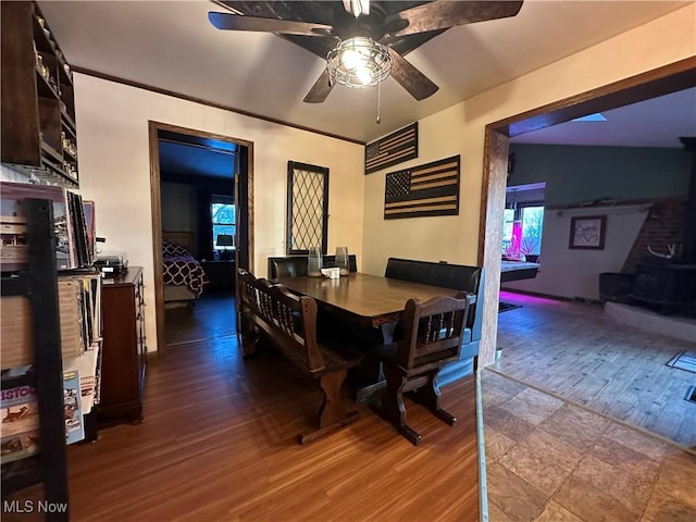 dining space featuring wood-type flooring, plenty of natural light, ornamental molding, and ceiling fan