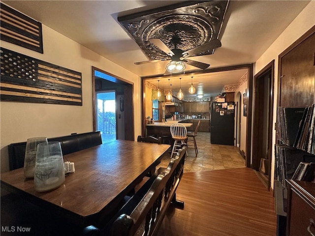 dining area featuring ceiling fan and hardwood / wood-style floors