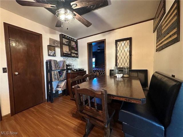 dining area with hardwood / wood-style flooring, ceiling fan, and crown molding