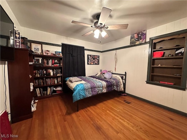 bedroom featuring wood-type flooring and ceiling fan