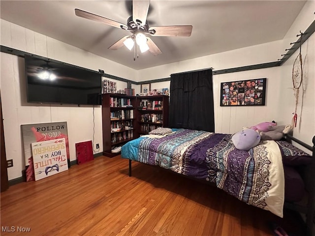 bedroom with ceiling fan and wood-type flooring