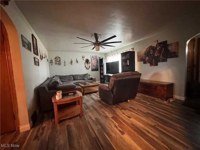 living room with dark hardwood / wood-style floors and ceiling fan