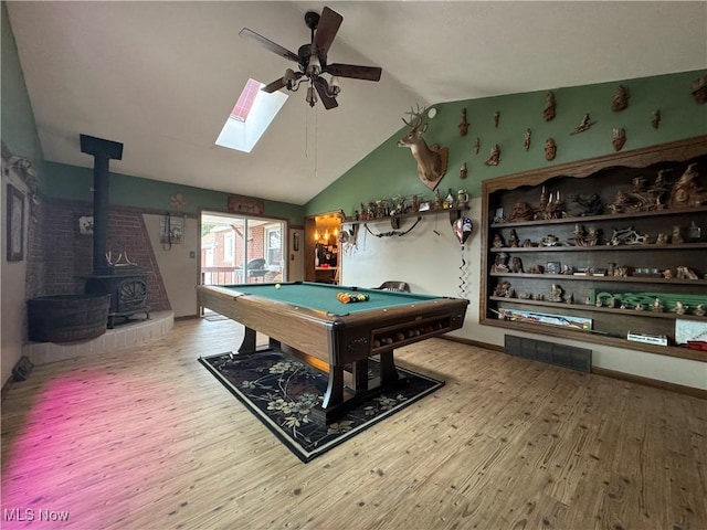 rec room with billiards, lofted ceiling, wood-type flooring, a wood stove, and ceiling fan