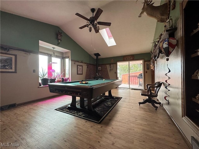 rec room featuring hardwood / wood-style flooring, vaulted ceiling with skylight, ceiling fan, and billiards