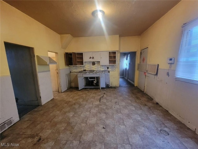 kitchen featuring decorative backsplash and white cabinets