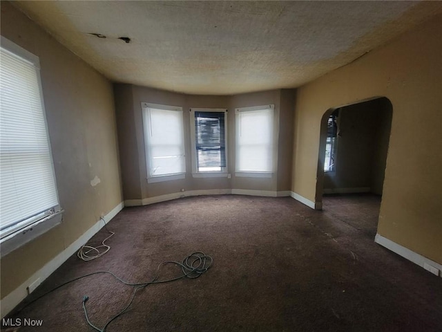 unfurnished room featuring a textured ceiling