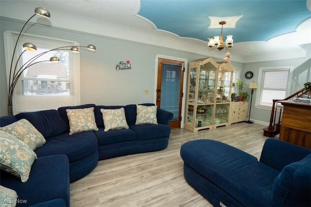 living room featuring a notable chandelier and light hardwood / wood-style flooring