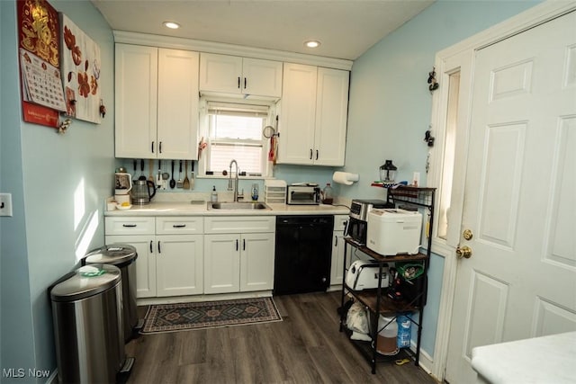 kitchen featuring dark hardwood / wood-style floors, dishwasher, sink, and white cabinets