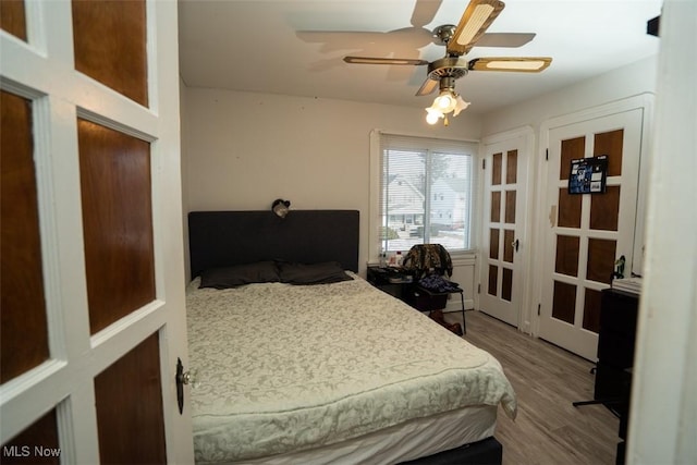 bedroom with hardwood / wood-style flooring and ceiling fan