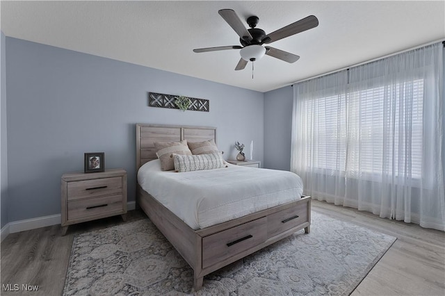 bedroom with wood-type flooring and ceiling fan