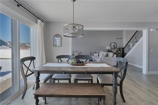 dining space with light hardwood / wood-style floors